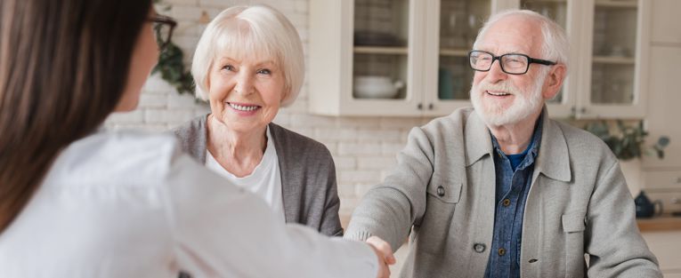 senior-couple-get-help-from-young-woman